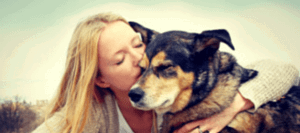 girl kissing her dog