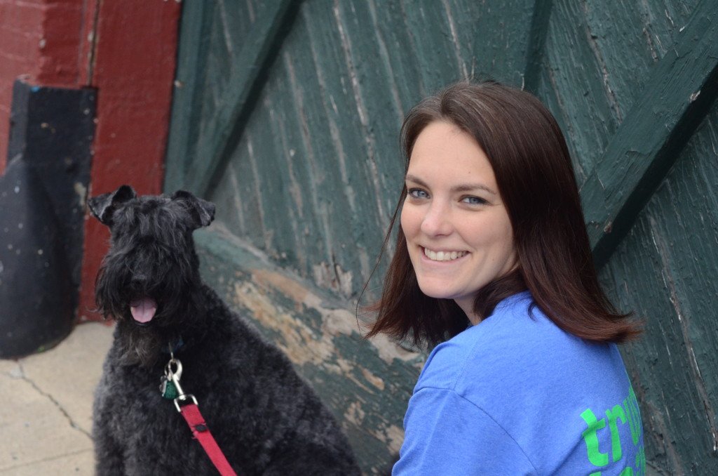 a girl with her black dog