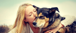 girl kissing her dog